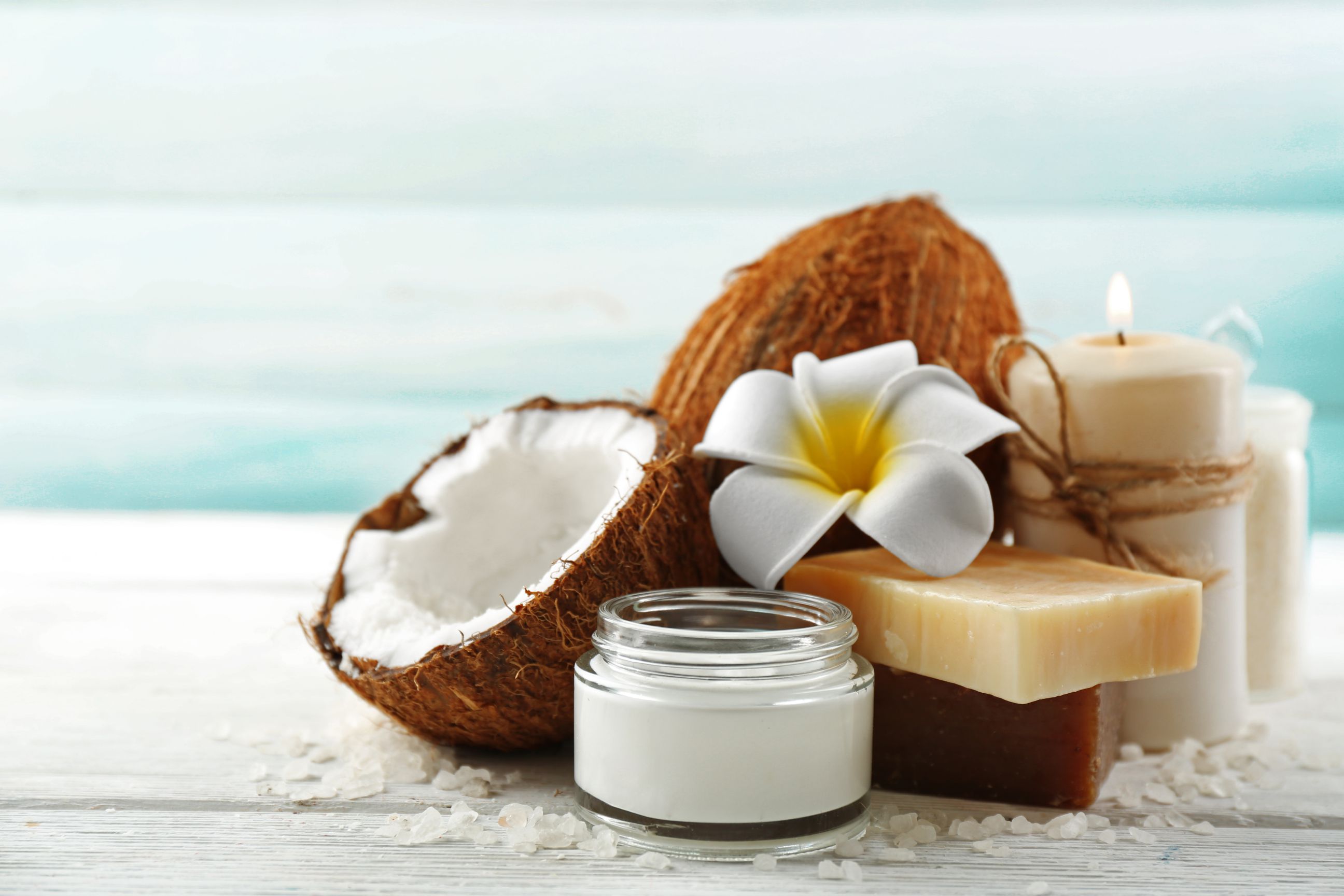 Spa coconut products on light wooden background