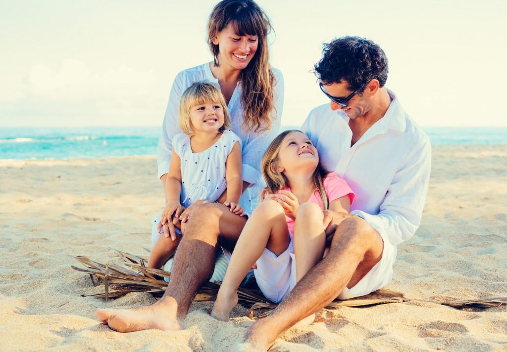 Pair with kids on the beach