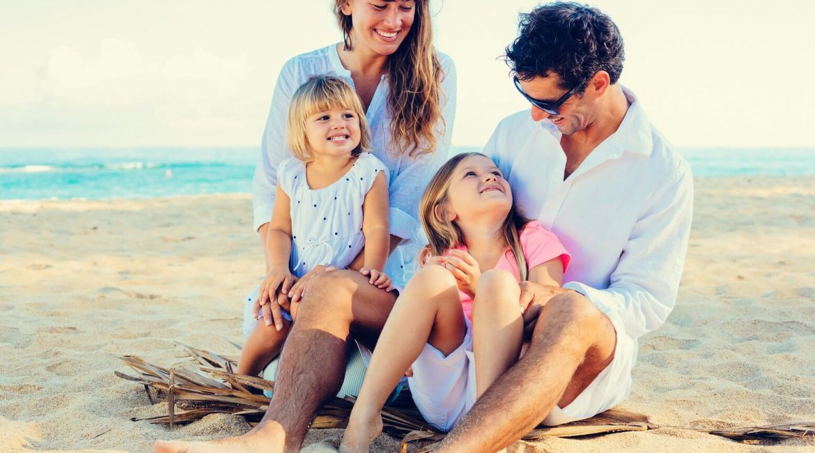 Pair with kids on the beach