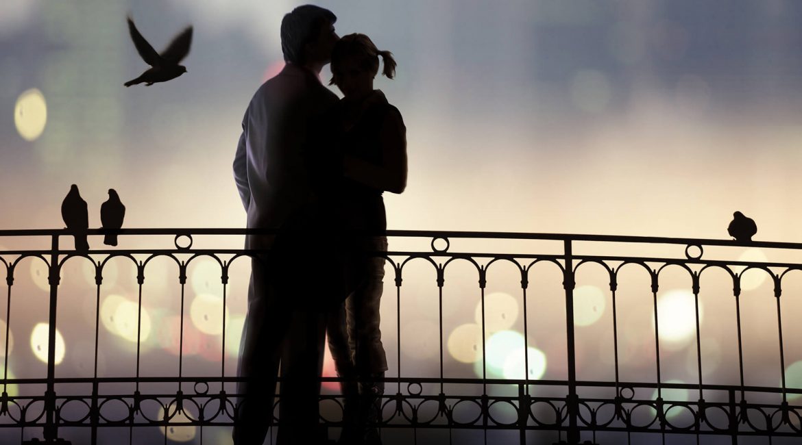 a man hugs woman on the bridge